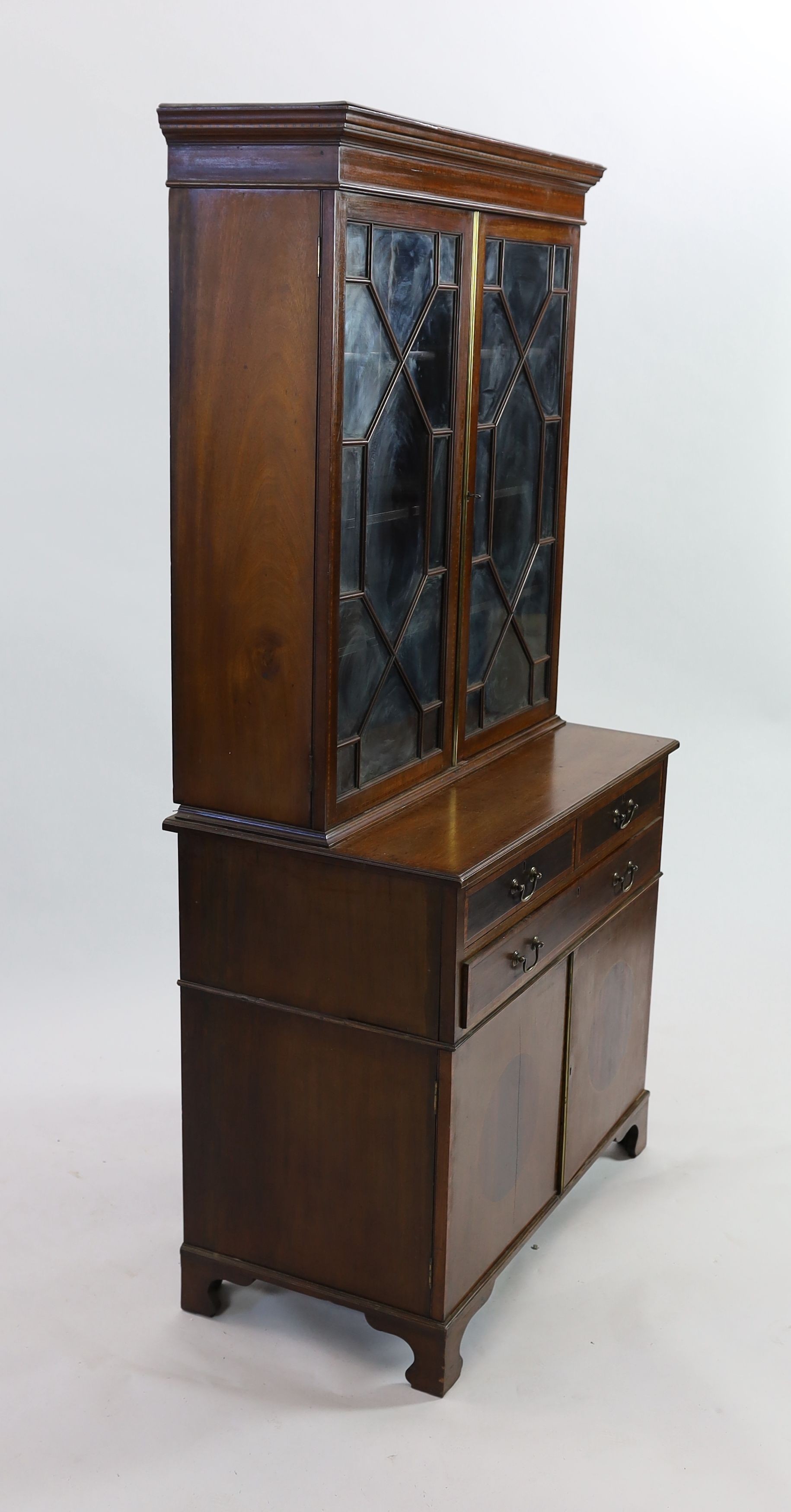 An Edwardian satinwood banded mahogany bookcase cupboard, fitted three drawers, width 91cm depth 50cm height 182cm
